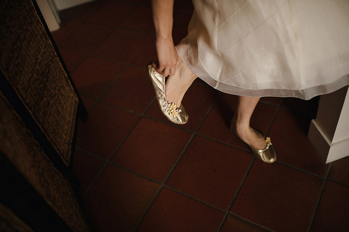 bride putting shoes on
