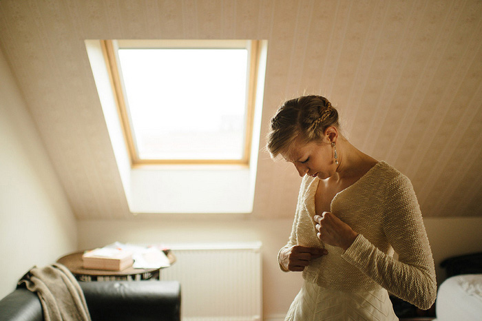 bride buttoning sweater