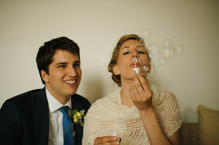 bride blowing bubbles