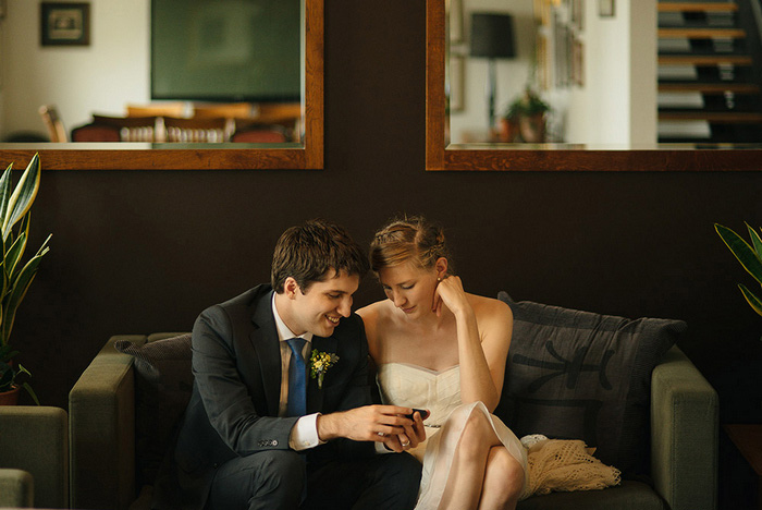 bride and groom sitting on couch