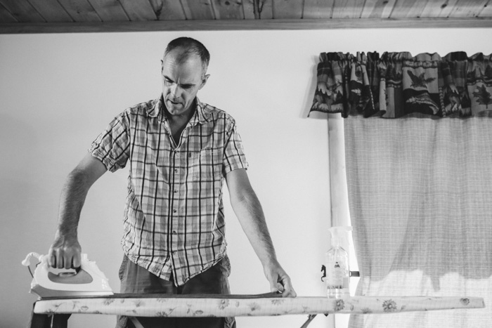 groom ironing shirt