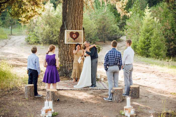 bride and groom hugging at altar