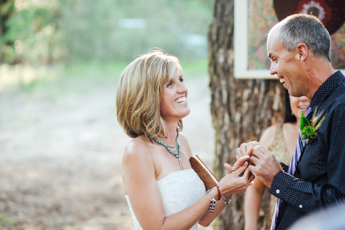 groom putting ring on bride's finger