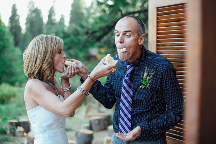 bride and groom feeding each other cake