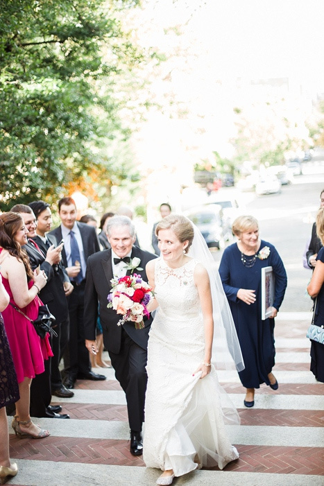 bride walking up steps with father