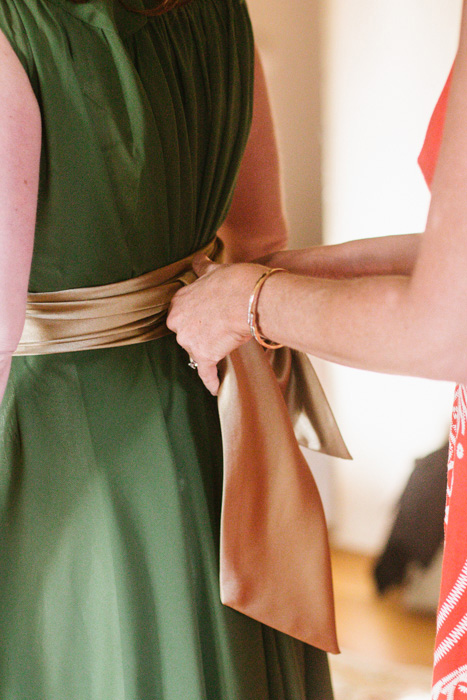 tying bridesmaid's sash