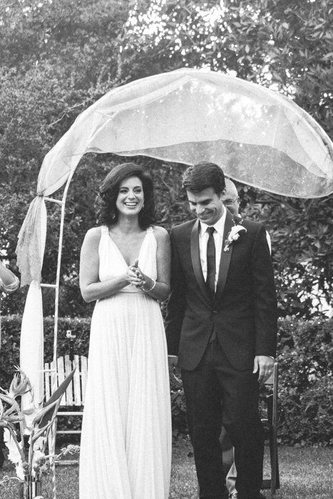 bride and groom facing guests at ceremony