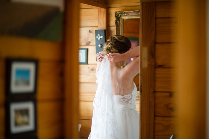 bride putting on veil