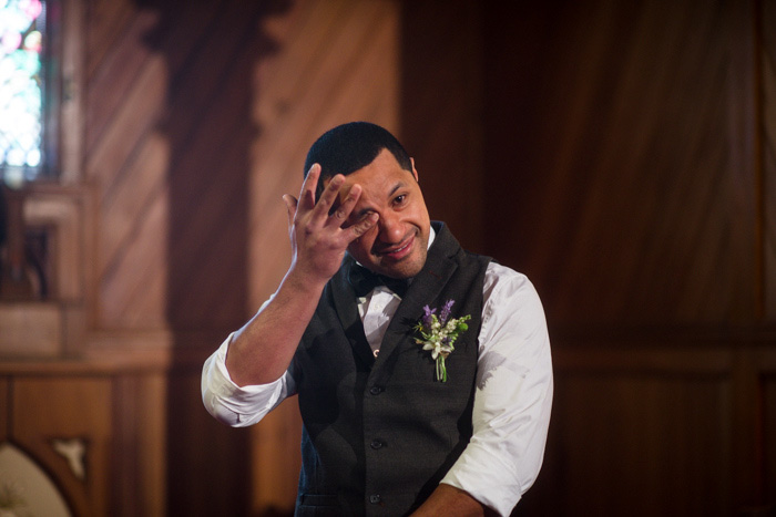 emotional groom at the altar