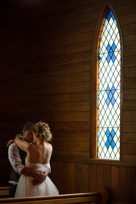 bride and groom hugging in church