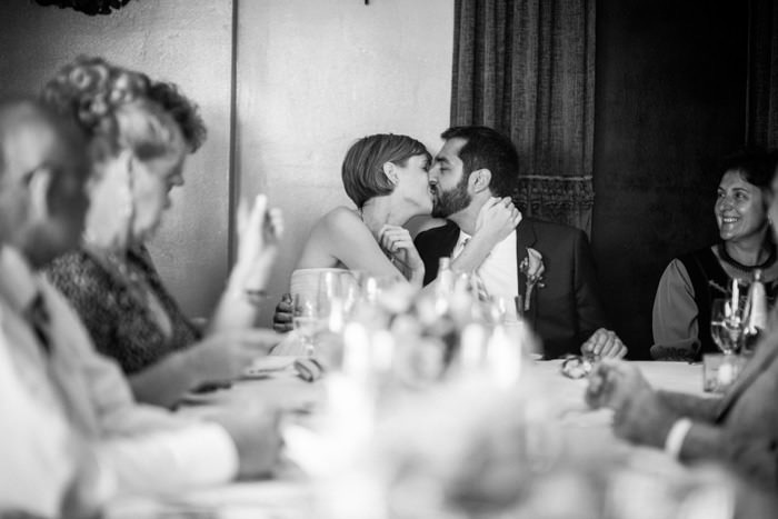 bride and groom kissing at reception