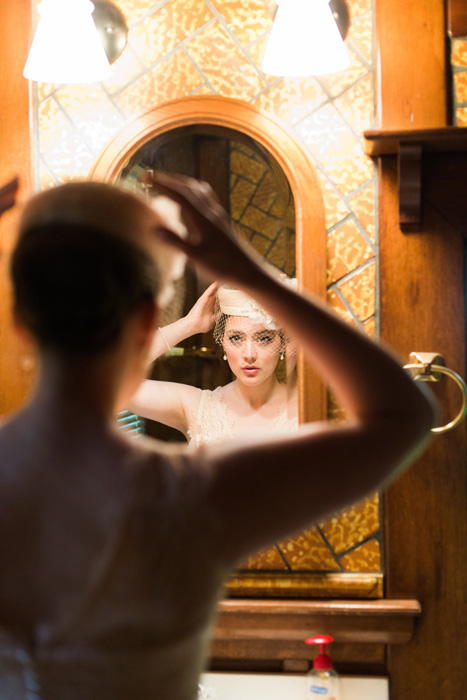 bride putting on pillbox hat