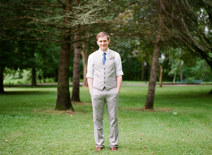 groom in vest and blue tie