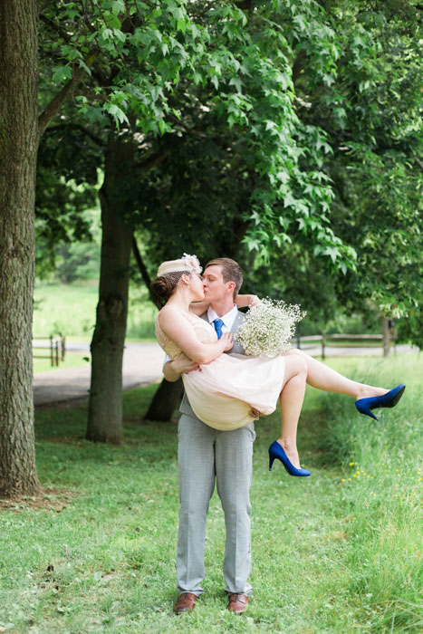 groom carrying bride