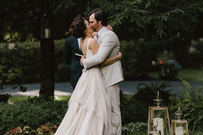 bride and groom first kiss