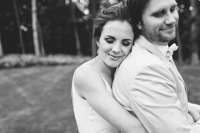 bride hugging groom from behind