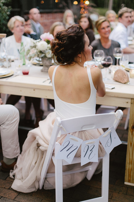 bride with Mrs. sign on her chair