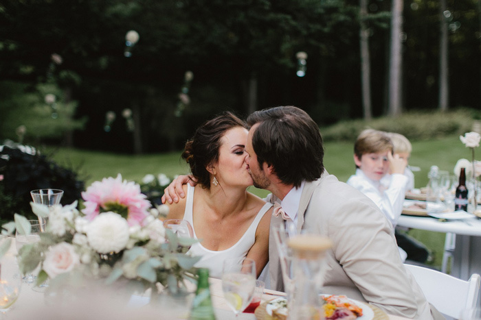 bride and groom kissing at reception