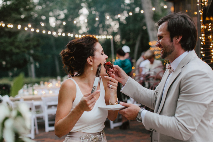 groom feeding bride chocolate covered strawberry