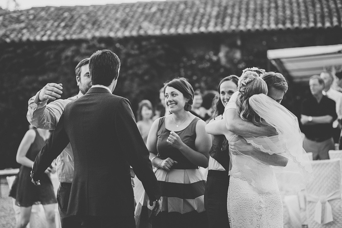 bride and groom hugging guests