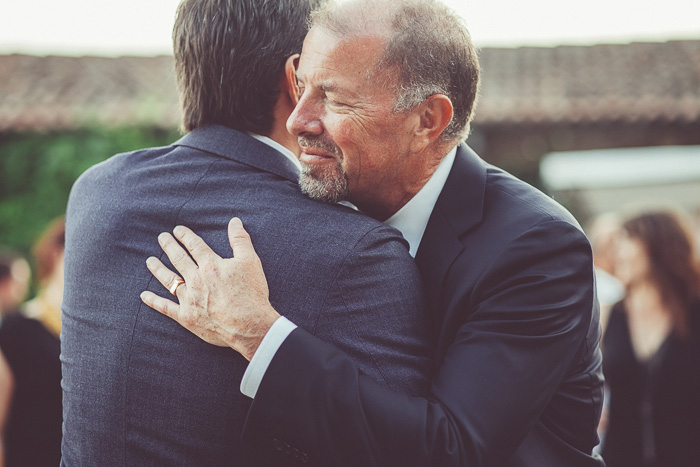 groom hugging father-in-law