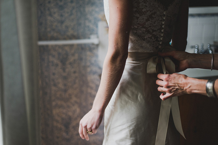 bride getting sash tied