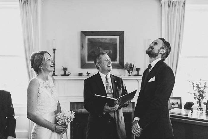 bride and groom laughing during ceremony