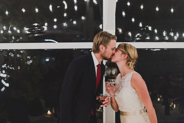 bride and groom kissing at reception