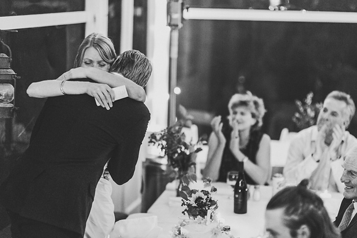 bride and groom hugging at reception