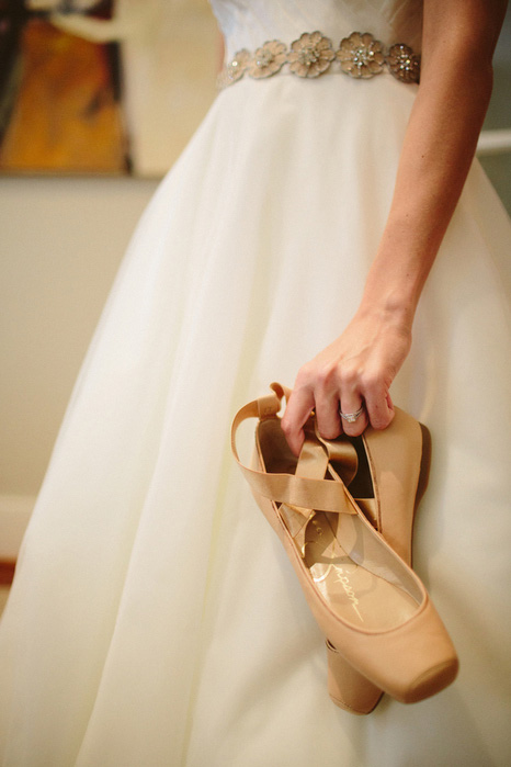 bride holding ballet flats