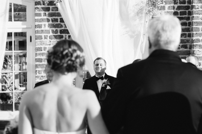 groom watching bride walk down aisle