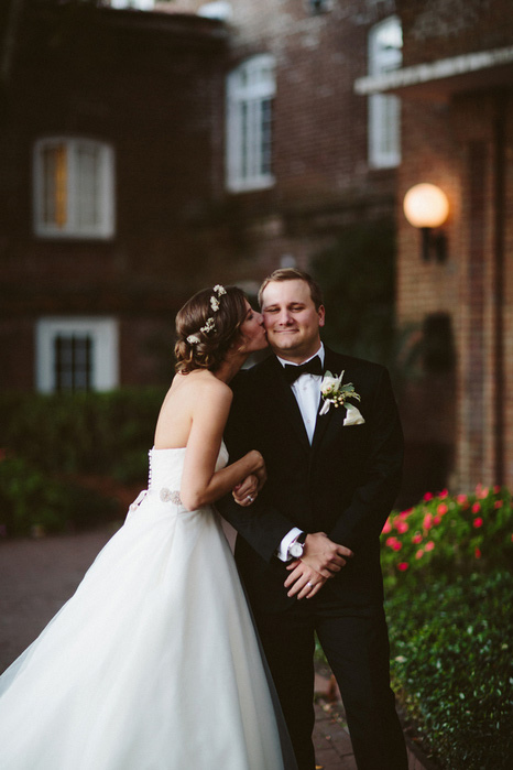 bride kissing groom on cheek