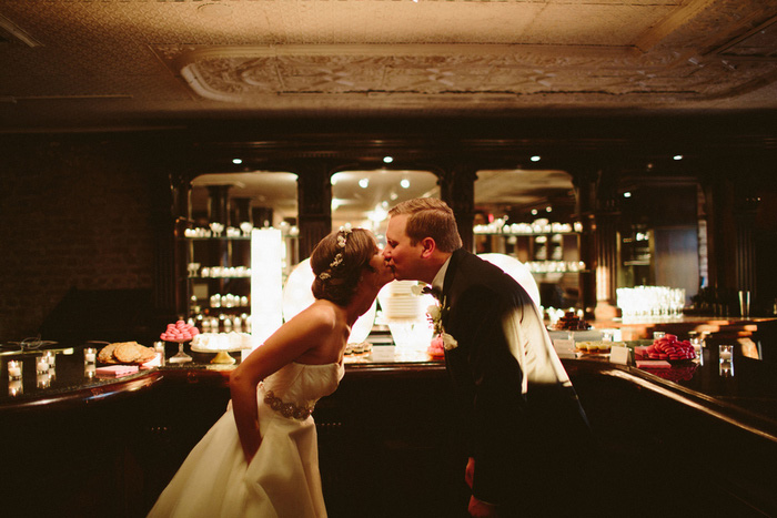 bride and groom kissing at reception