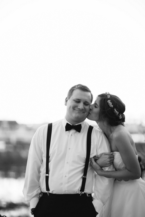 bride kissing groom on cheek