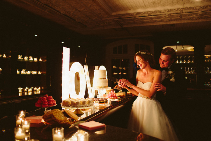 bride and groom cutting cake