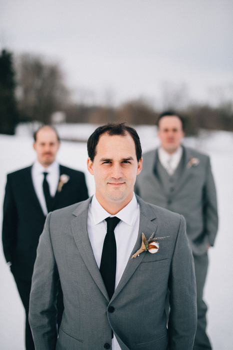 groom and groomsmen in the snow