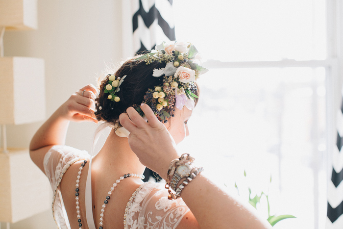 bride putting on flower crown