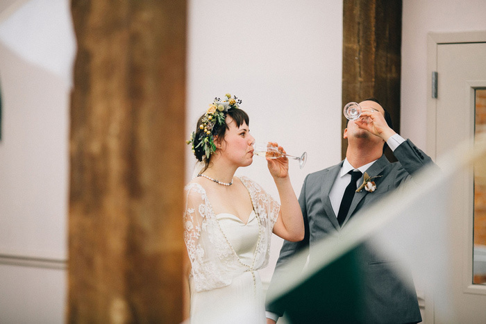 bride and groom drinking champagne