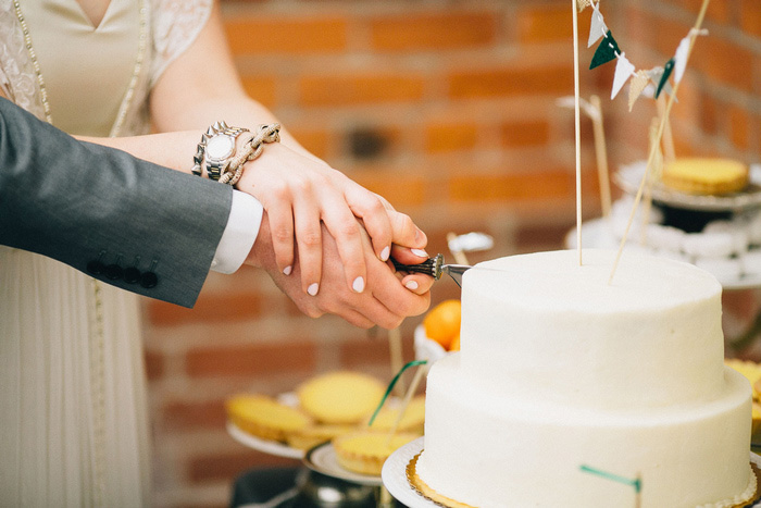 bride and groom cutting cake