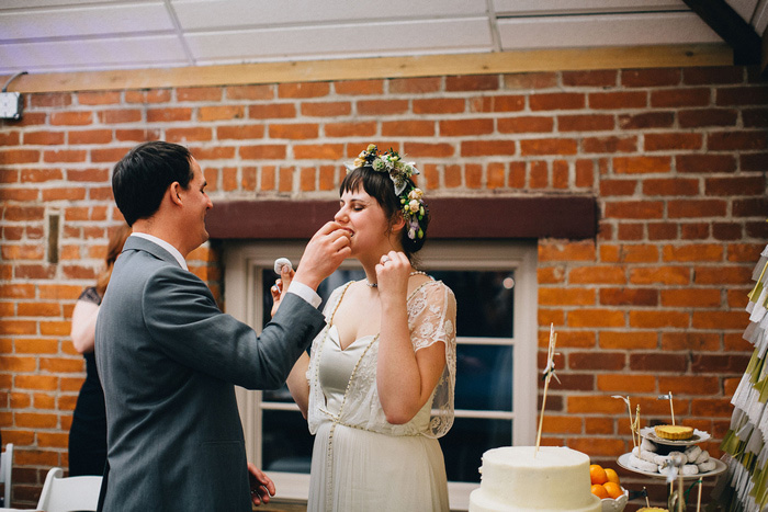 groom feeding bride cake