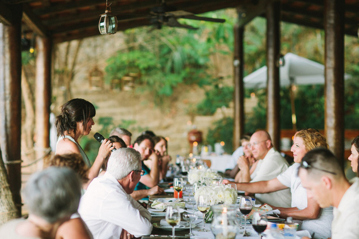 wedding guests at reception dinner on resort porch