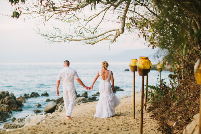 bride and groom waking on the beach