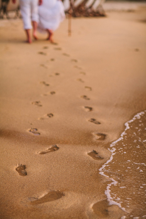 bride and groom footprints in the sand