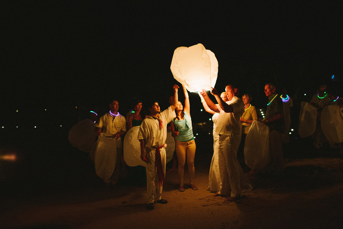 lighting a wish lantern on the beach