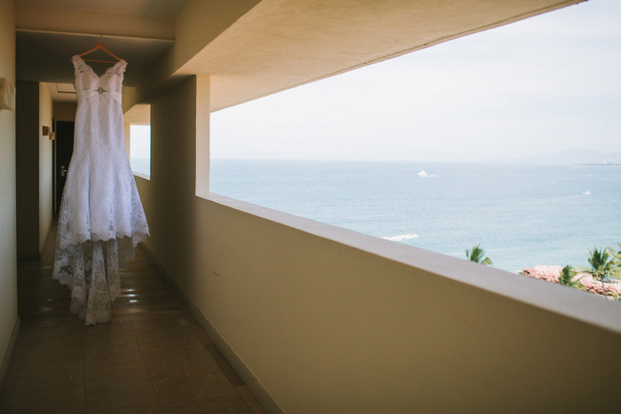 wedding dress hanging on resort balcony