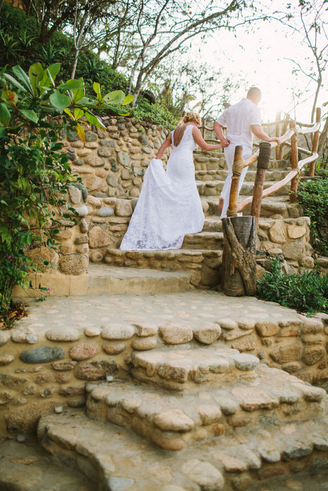 bride and groom climbing stone stairs