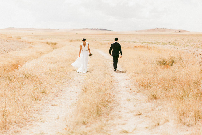 bride and groom walking in countryside