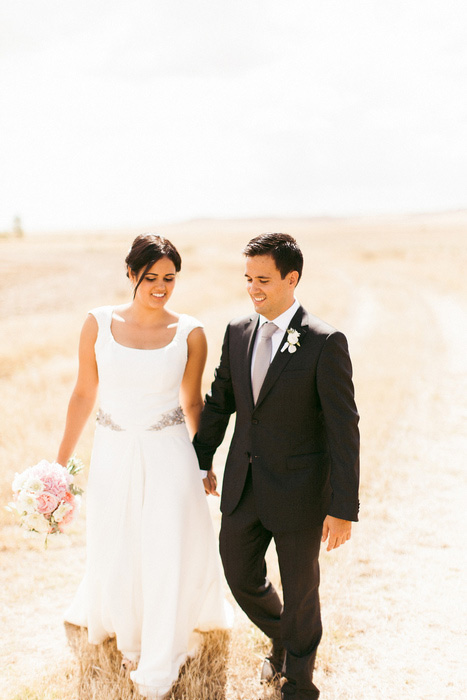 bride and groom walking in countryside