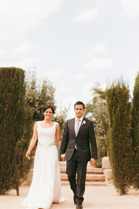 bride and groom walking hand in hand