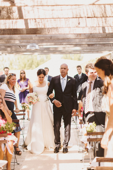 bride walking down the aisle with her father